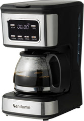 programmable coffee maker with reusable filter on a kitchen counter next to a coffee pot