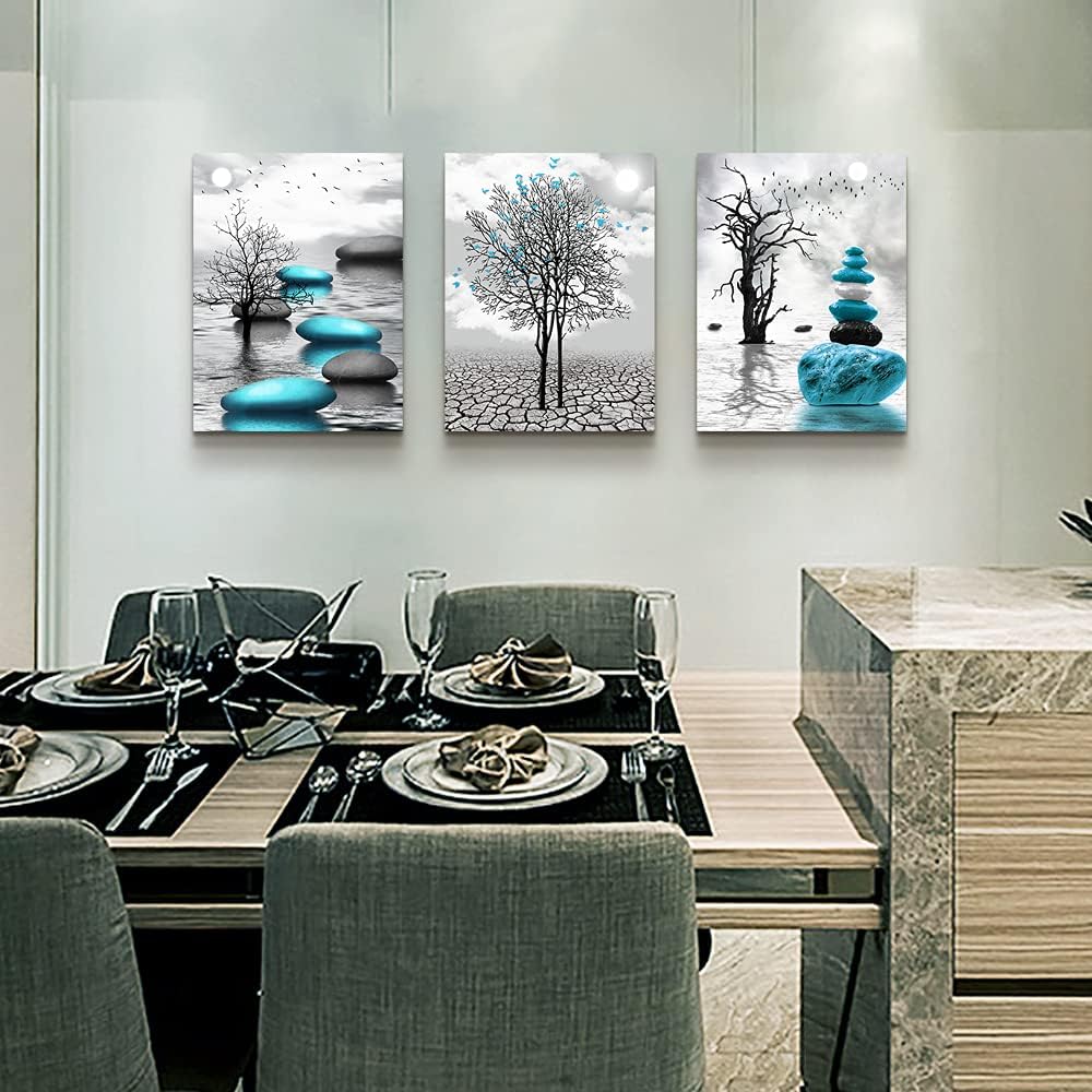 modern abstract canvas wall art featuring blue and black designs with trees and stones on a dining room wall