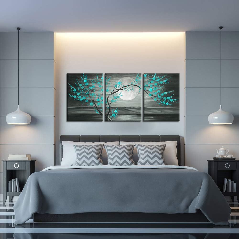 teal plum blossom wall art 12x16" Framed Canvas Set displayed above a modern bed in a stylish bedroom interior.