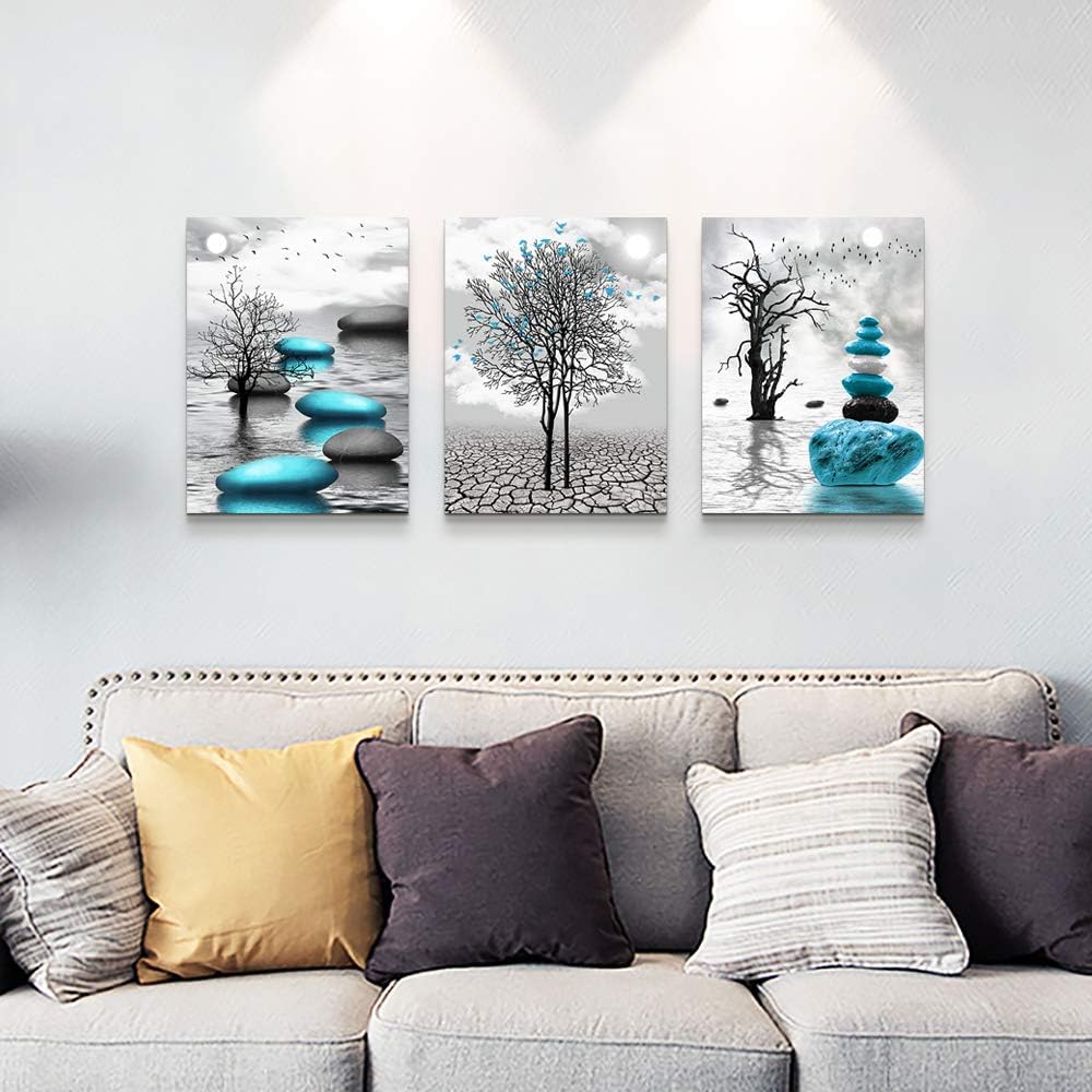 modern abstract canvas wall art featuring blue and black elements with trees and stones on a minimalist wall.