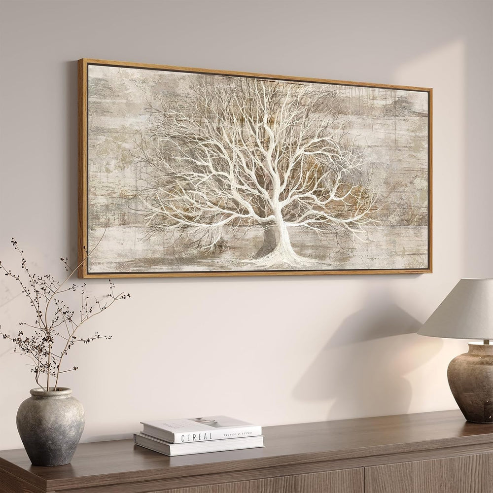 Large gold tree of life wall art displayed in a modern living room on a neutral wall.