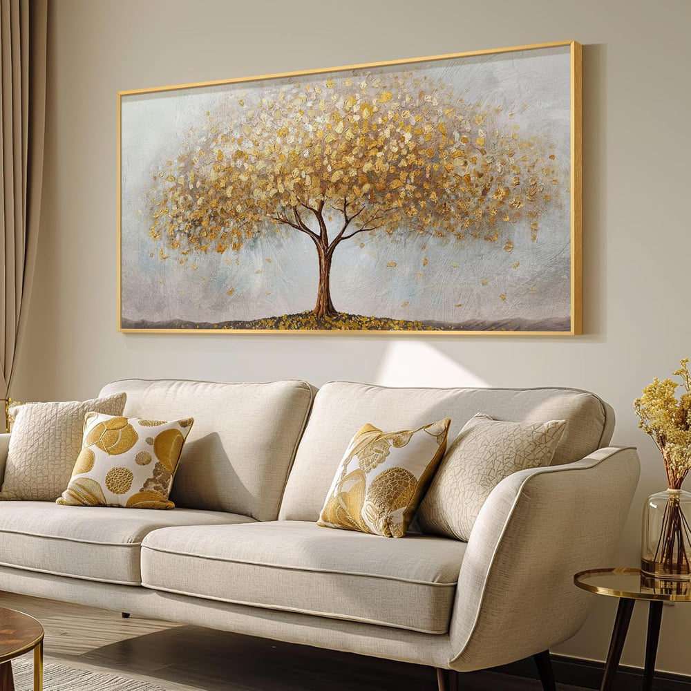 Large gold tree of life wall art displayed above a light sofa in a cozy living room setting.