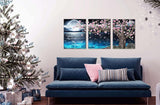 3 piece canvas wall art set showcasing a pink tree and moon decor above a blue sofa with a Christmas tree nearby.
