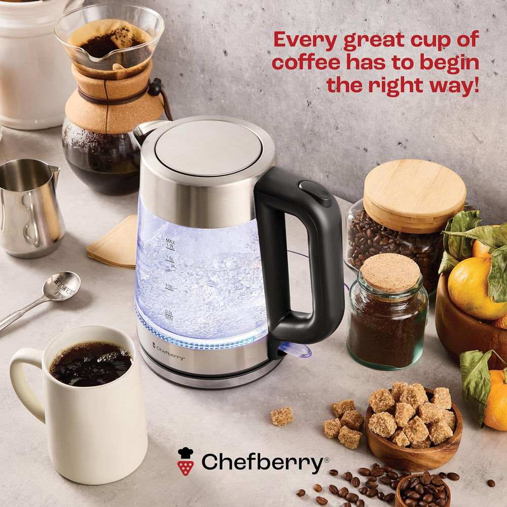 glass electric kettle BPA-free beside coffee ingredients and a cup of coffee.